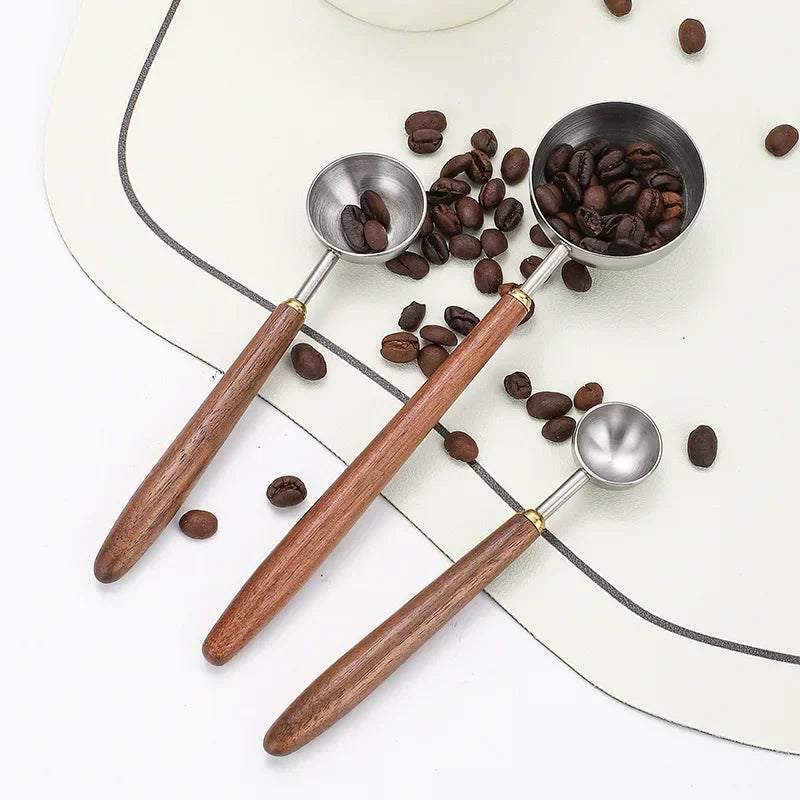 Elegant and practical coffee scoop with a durable wooden handle for precise measuring.